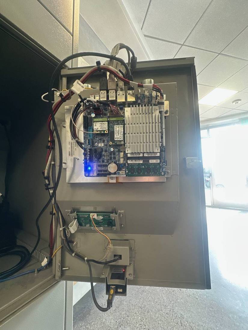 Mainboard, peripherals, and cable harness inside a kiosk
