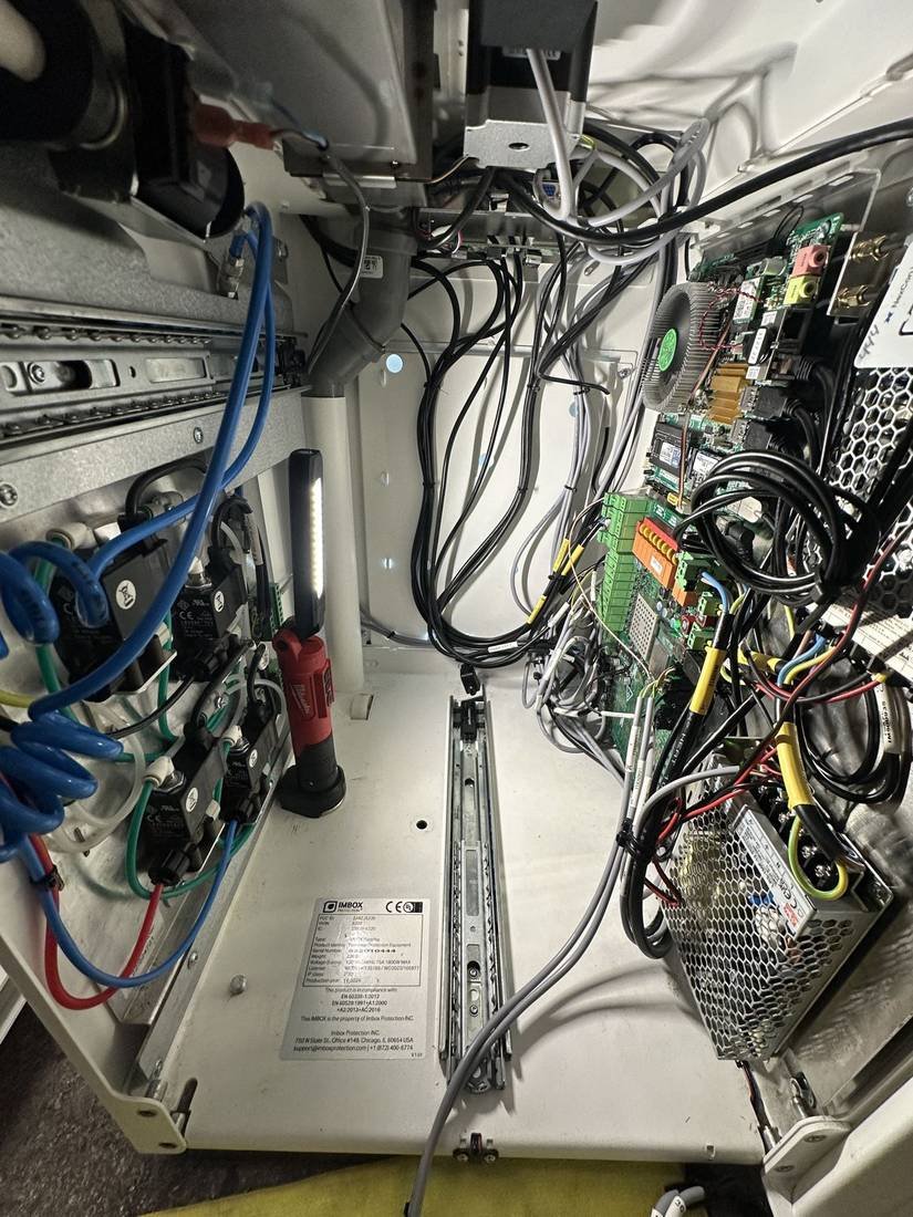 Cabinet wiring, power, and controller boards inside a retail kiosk