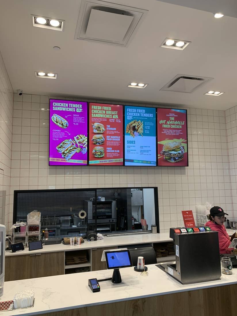 Digital menu boards and POS terminals at a service counter