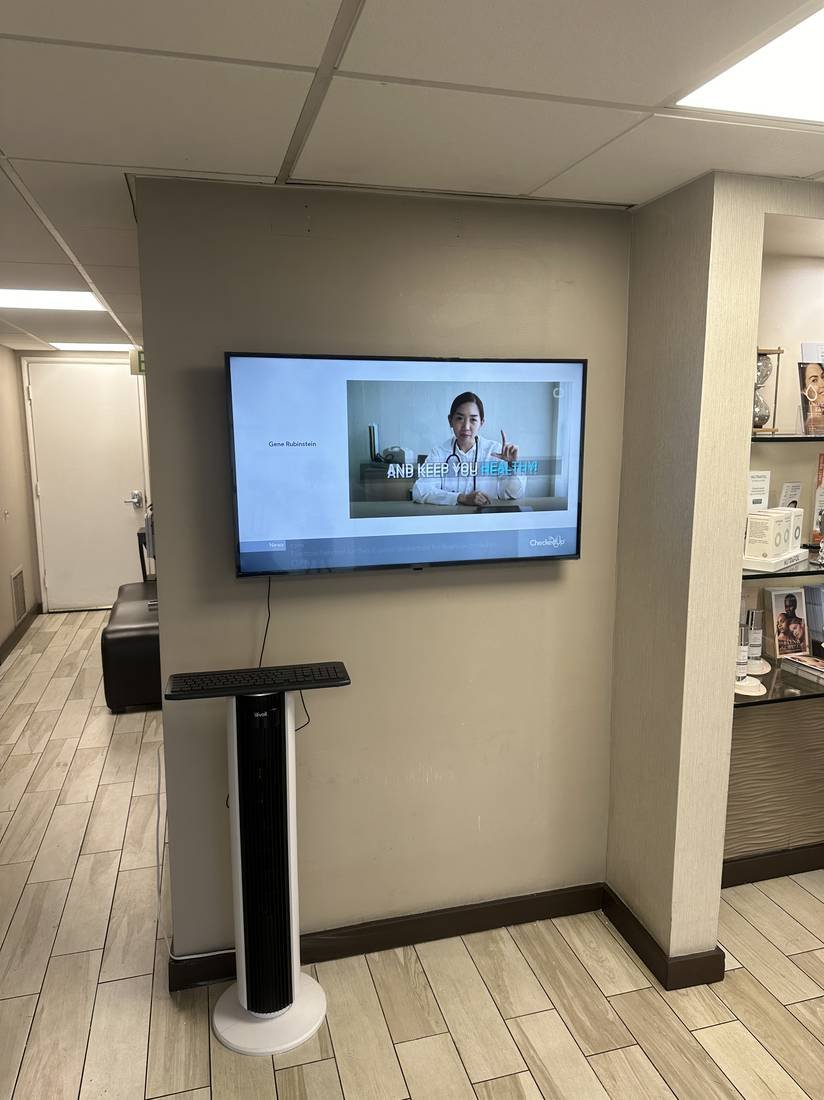 Wall-mounted display in a clinical waiting area