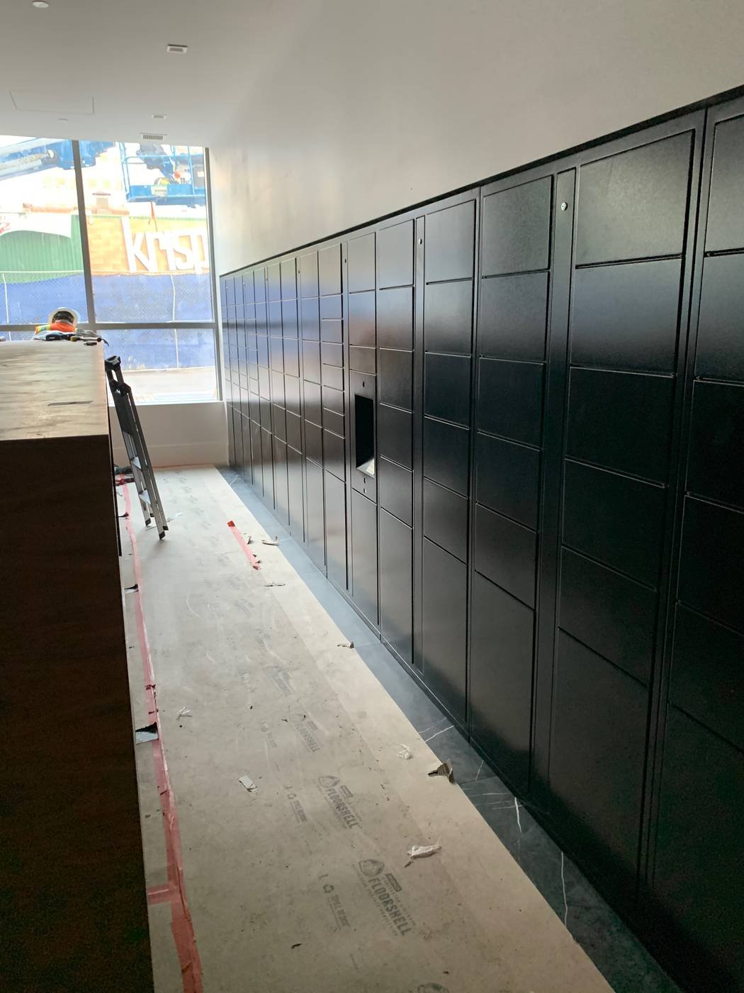 Parcel locker bank installed in an apartment mailroom