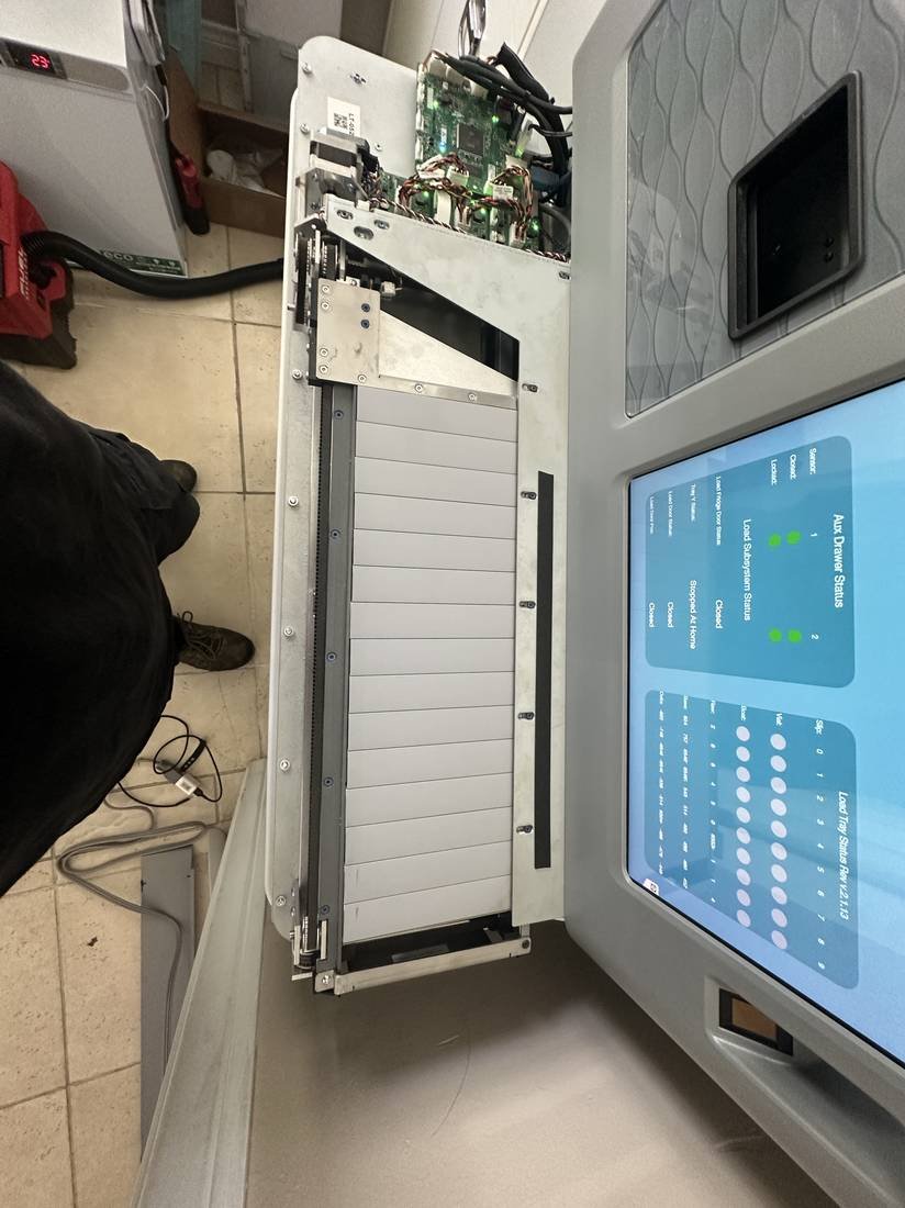 Self-service kiosk with the panel dropped for internal access