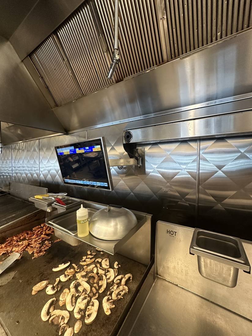 Menu board display mounted in a commercial kitchen